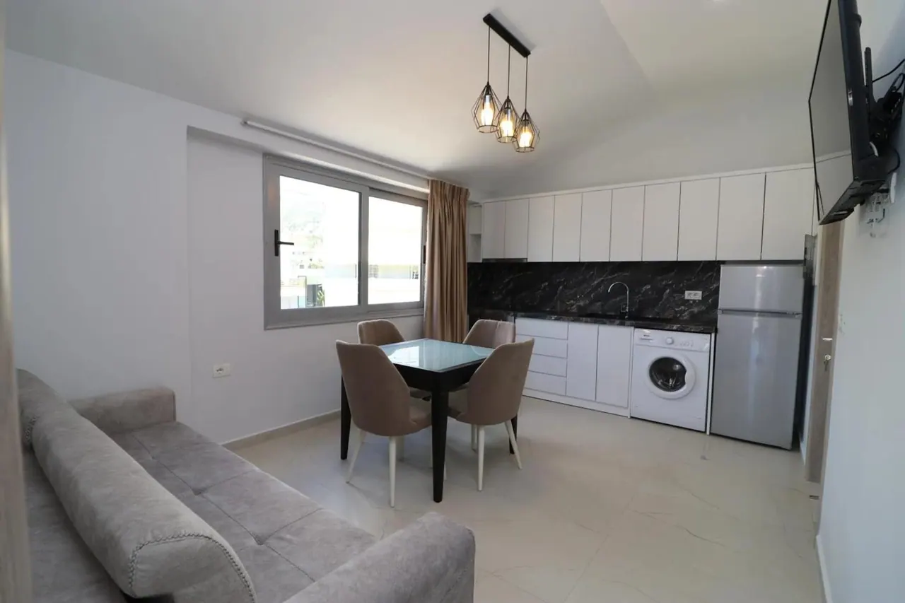 Apartment kitchen and dining area with a balcony beyond