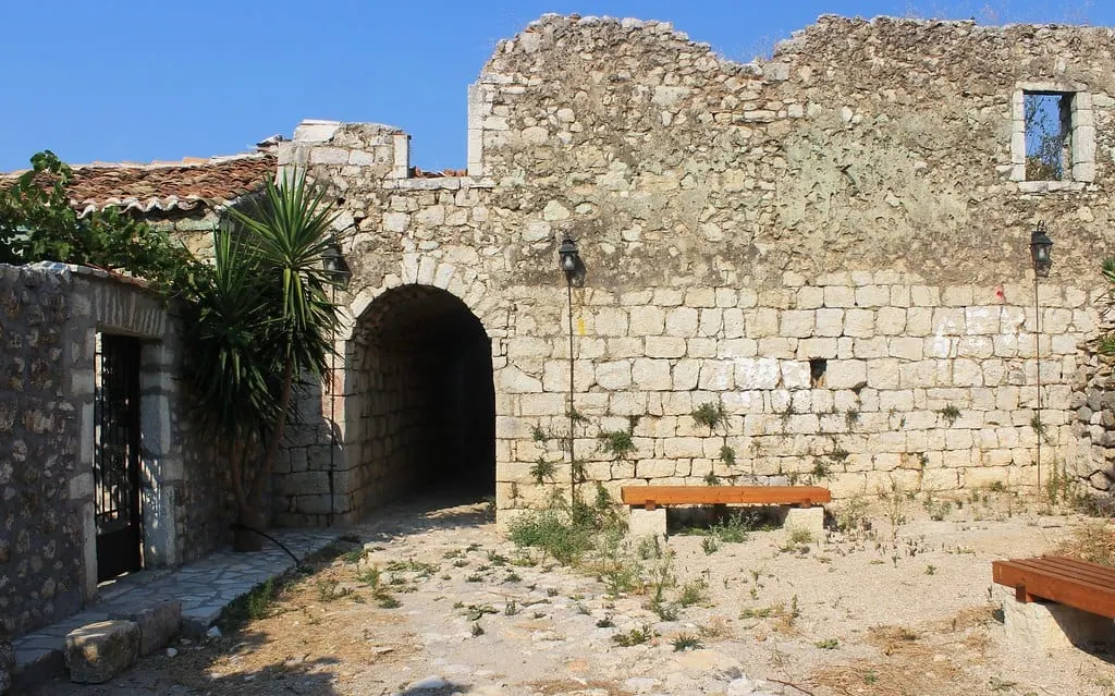 The arched stone gateway of Himarë Castle in the old town