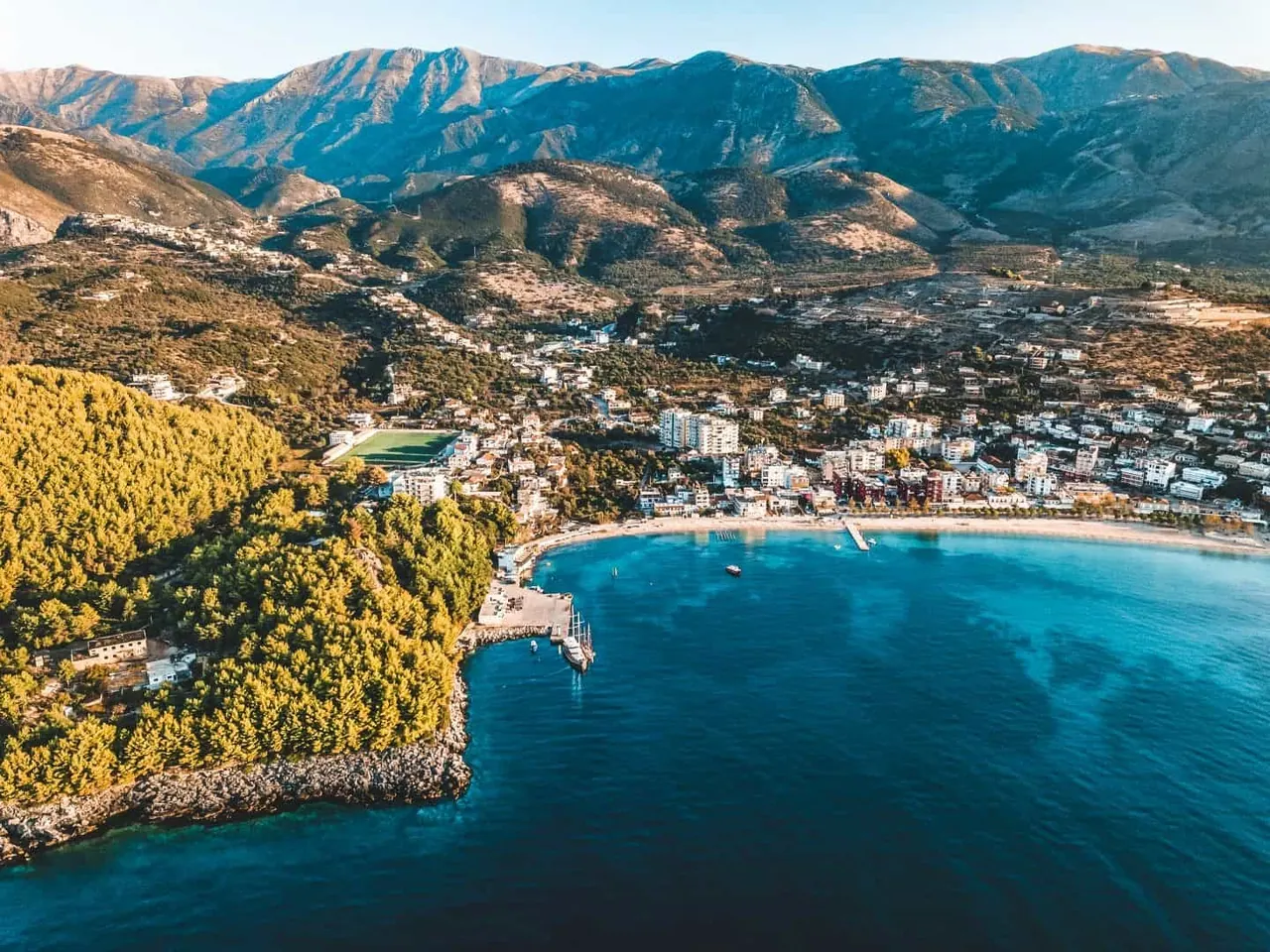 Aerial view of Himarë town and its turquoise bay from the north